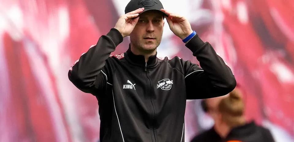 Тренер adjusts cap on sidelines during match