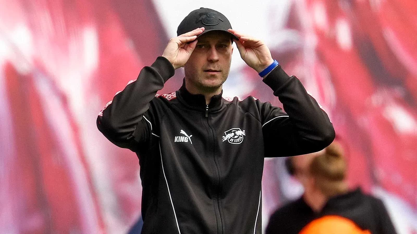 Тренер adjusts cap on sidelines during match